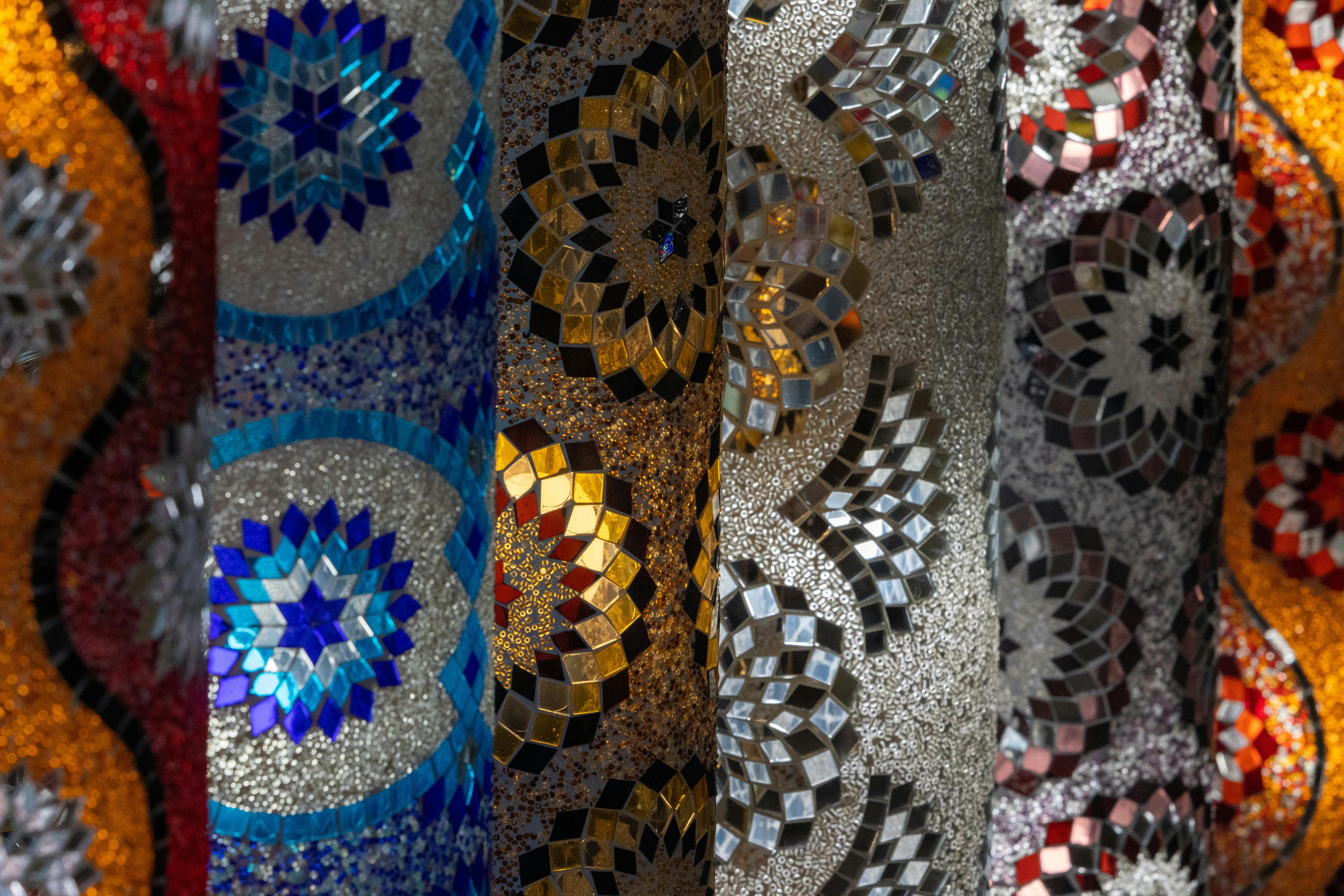 Close-up of vibrant mosaic designs showcasing colorful and intricate patterns in various shades and textures.